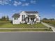 Modern farmhouse exterior with landscaped yard and driveway at 3705 Ridge Run Dr, Minneola, FL 34715