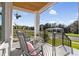 Relaxing covered front porch with rocking chairs overlooking the serene view at 3705 Ridge Run Dr, Minneola, FL 34715