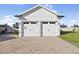 View of the detached two-car garage with brick-paved driveway of this beautiful home at 3705 Ridge Run Dr, Minneola, FL 34715