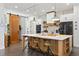 Modern kitchen boasts a large island, a barn door, and stainless steel appliances at 3705 Ridge Run Dr, Minneola, FL 34715