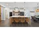 Bright kitchen with a large island, bar stool seating, and modern appliances with an open plan at 3705 Ridge Run Dr, Minneola, FL 34715