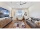 Relaxing living room with hardwood floors, comfortable seating, and large TV at 3705 Ridge Run Dr, Minneola, FL 34715