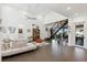 Light-filled living room with a modern staircase, high ceilings, and stylish furniture at 3705 Ridge Run Dr, Minneola, FL 34715
