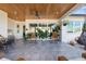 A covered patio with a wood ceiling, comfortable seating, and views of the backyard at 3705 Ridge Run Dr, Minneola, FL 34715