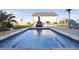 Gorgeous pool with lounge chairs, a built-in grill, and a view of the home's backyard at 3705 Ridge Run Dr, Minneola, FL 34715