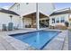Inviting pool area with lounge chairs, outdoor furniture, heaters, and a covered patio at 3705 Ridge Run Dr, Minneola, FL 34715
