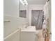 Clean bathroom with white tile, vanity, and shower/tub combo at 4213 Seybold Ave, Orlando, FL 32808