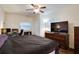 Bright bedroom featuring a large bed, workspace, and TV at 4213 Seybold Ave, Orlando, FL 32808