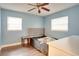 Bedroom with light blue walls, ceiling fan, and double bed at 4213 Seybold Ave, Orlando, FL 32808