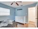 Bedroom with light blue walls, ceiling fan, and dresser at 4213 Seybold Ave, Orlando, FL 32808