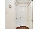 Hallway with wood floors and three white doors at 4213 Seybold Ave, Orlando, FL 32808