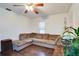 Cozy living room featuring a brown L-shaped sectional sofa and wood floors at 4213 Seybold Ave, Orlando, FL 32808