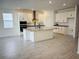 Modern kitchen with island, white cabinets, and stainless steel appliances at 4421 Lions Gate Ave, Clermont, FL 34711