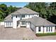 Luxury home with gray metal roof and circular driveway at 5049 Lake Howell Rd, Winter Park, FL 32792