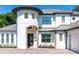 Two-story house with a circular tower and a gray metal roof at 5049 Lake Howell Rd, Winter Park, FL 32792