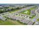 A high aerial shot showcases an orderly neighborhood with matching homes and community green spaces at 7836 June Ln, Wildwood, FL 34785