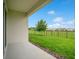 View of backyard features green grass, a young tree, and a black fence, offering a private outdoor space at 7836 June Ln, Wildwood, FL 34785