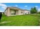 The home has a spacious backyard with a sliding glass door and a black metal fence at 7836 June Ln, Wildwood, FL 34785