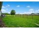 View of the green backyard and metal fence at 7836 June Ln, Wildwood, FL 34785