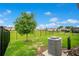 Backyard with green grass, tree, and metal fence at 7836 June Ln, Wildwood, FL 34785