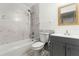Clean bathroom with grey vanity, marble tile, and shower/tub combo at 825 Kottle S Cir, Daytona Beach, FL 32114