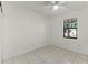 Bright bedroom with tile floors and a ceiling fan at 825 Kottle S Cir, Daytona Beach, FL 32114