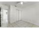 Simple bedroom with tile floors, double door closet, and ceiling fan at 825 Kottle S Cir, Daytona Beach, FL 32114