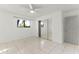 Bedroom with tile floors, ceiling fan, and mirrored closet at 825 Kottle S Cir, Daytona Beach, FL 32114