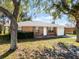 Brick ranch house with a white door and attached garage at 825 Kottle S Cir, Daytona Beach, FL 32114