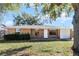 Brick ranch house with a white door and attached garage at 825 Kottle S Cir, Daytona Beach, FL 32114