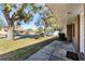 Brick home's front porch, showcasing a spacious yard and quiet street at 825 Kottle S Cir, Daytona Beach, FL 32114