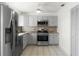 Modern kitchen with stainless steel appliances and grey cabinets at 825 Kottle S Cir, Daytona Beach, FL 32114