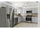 Bright kitchen with stainless steel appliances and gray cabinets at 825 Kottle S Cir, Daytona Beach, FL 32114