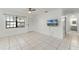 Bright living room with tile floors, ceiling fan, and access to other rooms at 825 Kottle S Cir, Daytona Beach, FL 32114