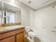 Clean bathroom with tub, toilet and wood vanity at 10951 Savannah Landing Cir, Orlando, FL 32832