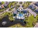 Aerial view of community center with pool, playground, lakeside setting, parking and luxurious landscaping at 1219 Verdant Glade Pl, Winter Park, FL 32792