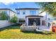 Spacious backyard with a patio, grill area, and well-maintained lawn perfect for outdoor entertaining at 1219 Verdant Glade Pl, Winter Park, FL 32792