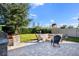 Outdoor fire pit and patio area with grill, surrounded by lush lawn and privacy fencing at 1219 Verdant Glade Pl, Winter Park, FL 32792
