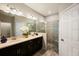 Bathroom with double sink vanity, tiled shower with glass door, and updated lighting at 1219 Verdant Glade Pl, Winter Park, FL 32792