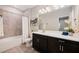 Bathroom with a bathtub, shower, black cabinets, white countertop and white flowers at 1219 Verdant Glade Pl, Winter Park, FL 32792