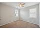 Bedroom with neutral walls, carpet, fan and two windows that let in natural light at 1219 Verdant Glade Pl, Winter Park, FL 32792