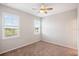 Bedroom with neutral walls, carpet, ceiling fan and two windows that let in natural light at 1219 Verdant Glade Pl, Winter Park, FL 32792