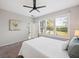 Bright bedroom with large window, ceiling fan, and view of the backyard at 1219 Verdant Glade Pl, Winter Park, FL 32792