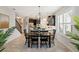 Bright dining area features a modern chandelier, and is adjacent to the kitchen with stainless steel appliances at 1219 Verdant Glade Pl, Winter Park, FL 32792