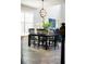 Dining area with modern light fixture, adjacent to a bright living room with high ceilings and large windows at 1219 Verdant Glade Pl, Winter Park, FL 32792