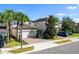 A beautiful home with a brick driveway, two-car garage, and landscaped front yard is seen on a bright sunny day at 1219 Verdant Glade Pl, Winter Park, FL 32792
