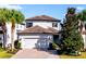 Charming two-story home featuring a well-manicured front yard, brick driveway and attached two car garage at 1219 Verdant Glade Pl, Winter Park, FL 32792