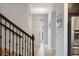 Bright foyer featuring tile floors, staircase with iron railing, and an open doorway to the outside at 1219 Verdant Glade Pl, Winter Park, FL 32792