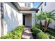 Inviting front entrance with a brick walkway, lush landscaping, and a welcoming covered porch at 1219 Verdant Glade Pl, Winter Park, FL 32792
