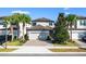 Charming two-story home with a well-manicured lawn, paver driveway, and attached two-car garage at 1219 Verdant Glade Pl, Winter Park, FL 32792